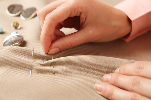 Closeup hands of seamstress at work with cloth fabric - Фото, зображення