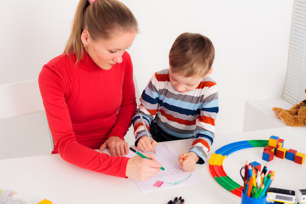 Young  woman drawing with her child - Foto, Imagen