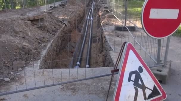new heating system pipes in trench and road signs - Footage, Video