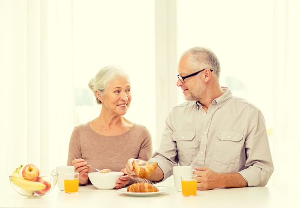 happy senior couple having breakfast at home - 写真・画像