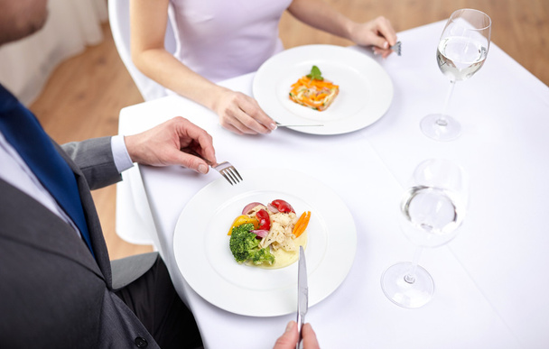 close up of couple eating appetizers at restaurant - Valokuva, kuva