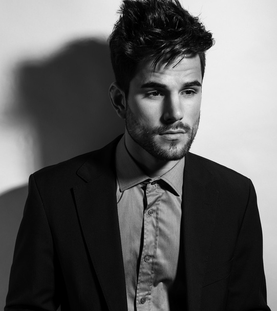 handsome young man in suit on grey background. Business man - Fotografie, Obrázek