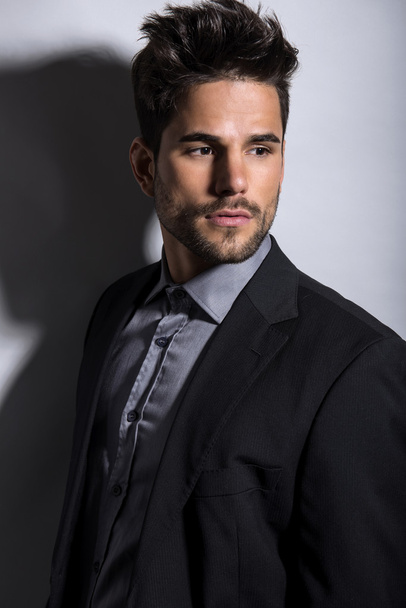 handsome young man in suit on grey background. Business man - Φωτογραφία, εικόνα
