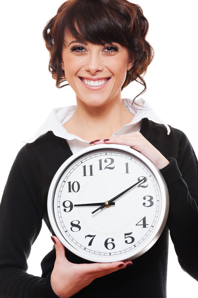 Smiley businesswoman holding clock - Fotoğraf, Görsel