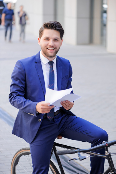 Handsome businessman riding his bicycle  - Foto, afbeelding