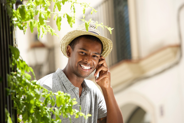 Happy guy calling with mobile phone outside - Photo, Image