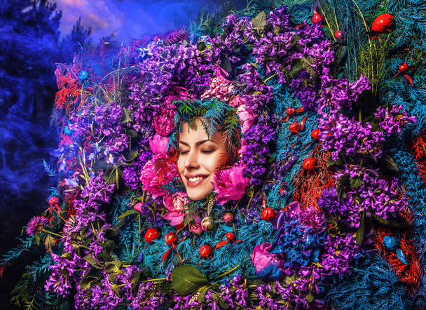 Fairy tale girl portrait surrounded with natural plants and flowers. Art image in bright fantasy stylization. - Fotoğraf, Görsel