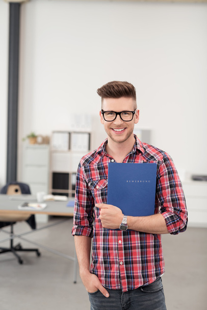 Cheerful Man Holding a Folder Inside the Office - Foto, afbeelding