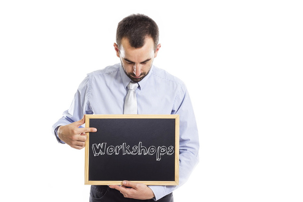 Workshops - Young businessman with blackboard - Photo, Image