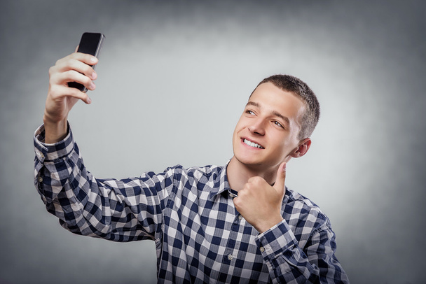 Happy young man taking a selfie. - Photo, Image