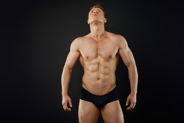 Attractive young sportsman is showing his perfect body - Fotografie, Obrázek