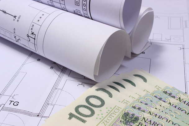 Rolls of electrical diagrams on construction drawing of house and money - Photo, Image