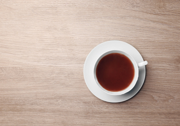 Cup of coffee on wooden table, top view - Photo, Image
