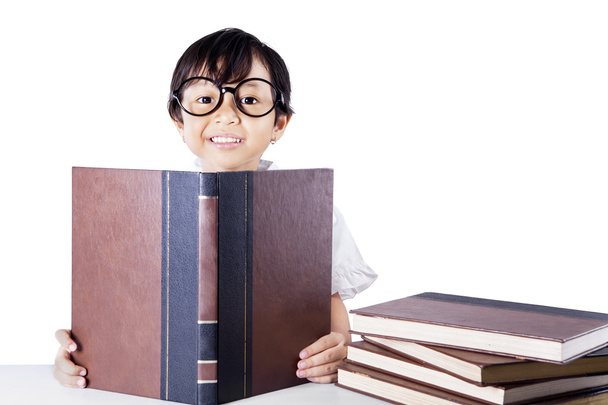 Clever schoolgirl reading books isolated - Fotografie, Obrázek