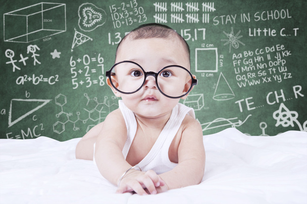 Funny baby with glasses and a doodles background - Valokuva, kuva