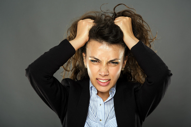Furious businesswoman pulling her hair - Photo, image