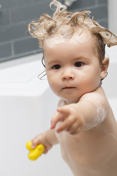 Little boy in bath with toy - Photo, image