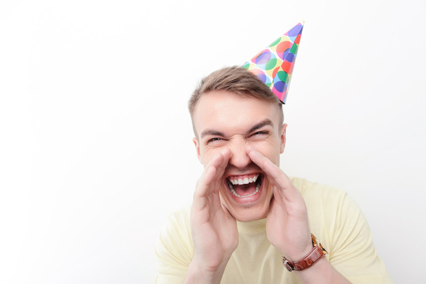 Close-up of crazy man wearing birthday hat - Фото, изображение