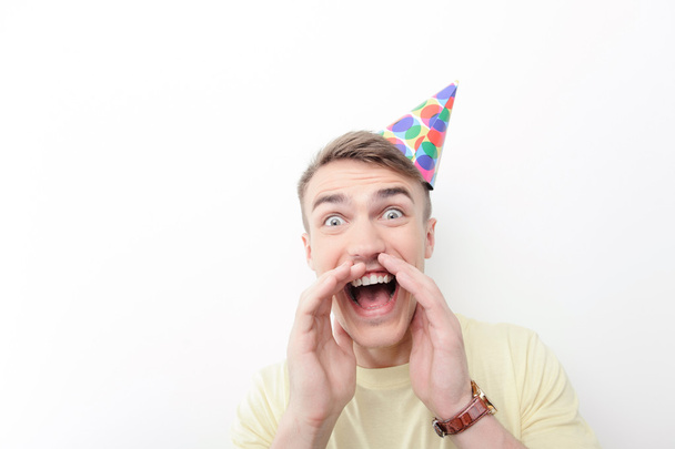 Close-up of crazy man wearing birthday hat - Foto, Imagem