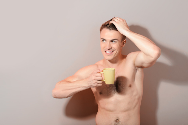 Handsome topless man holding cup of coffee - Fotoğraf, Görsel