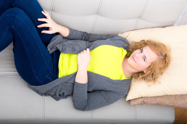 Young plus size woman relaxing on the Sofa	 - Foto, afbeelding