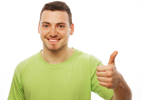 young man in green shirt  showing thumbs up.  - Photo, Image