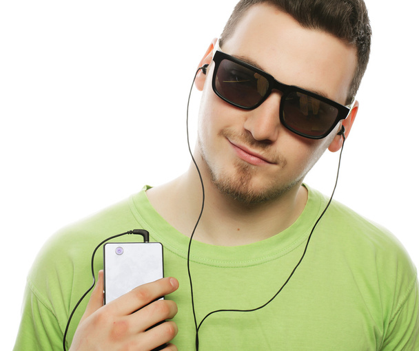 man listening music and using smartphone - Foto, afbeelding