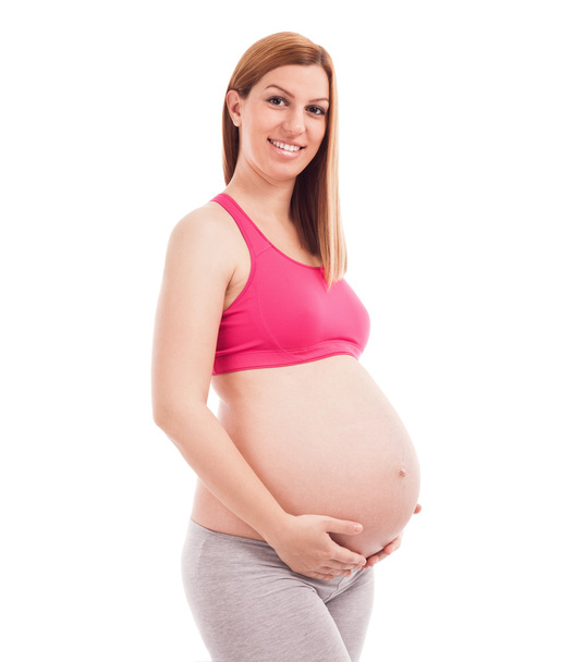 Pregnant woman holding her belly - Foto, Bild