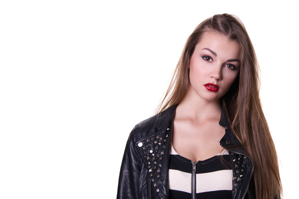 Beautiful girl with a red lipstick dressed in a black leather jacket. Isolated over white background.  Copy space. - Fotografie, Obrázek