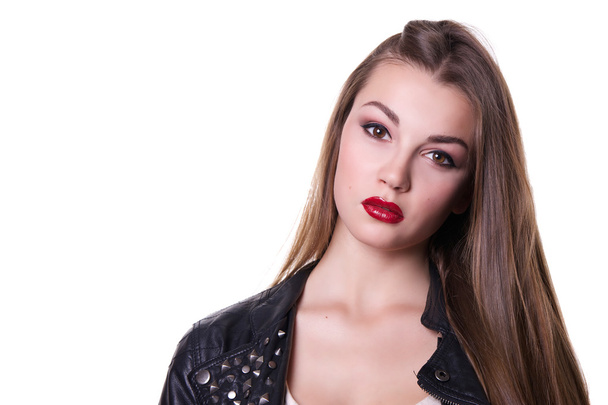 Beautiful girl with a red lipstick dressed in a black leather jacket. Isolated over white background.  Copy space. - Fotografie, Obrázek