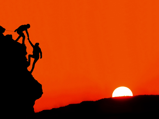 Silhouette of helping hand between two climber - Photo, Image