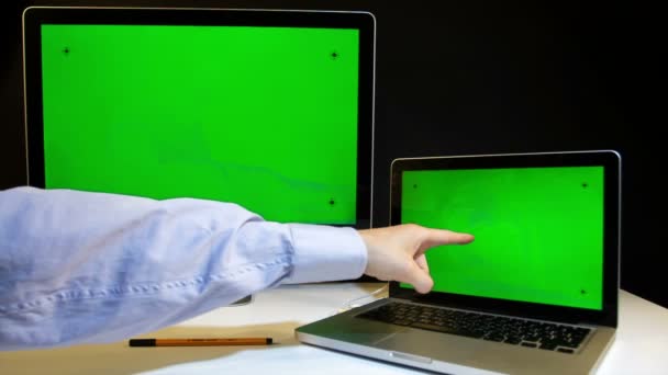 Man Working on the Laptop and Display with a Green Screen - Filmati, video
