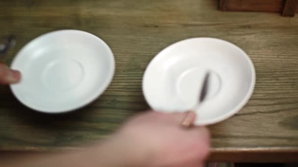 Barista θέσει δύο πιατάκια και δύο κουτάλια - Πλάνα, βίντεο
