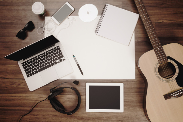 Office desk background acoustic guitar and headphones recording - Foto, afbeelding
