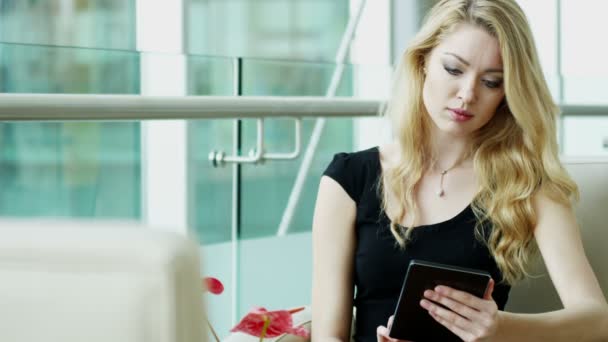 businesswoman in black dress using digital tablet - Materiał filmowy, wideo