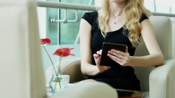 businesswoman in black dress using digital tablet - Video, Çekim