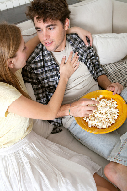 Couple watching television, eating pop corn - Foto, afbeelding