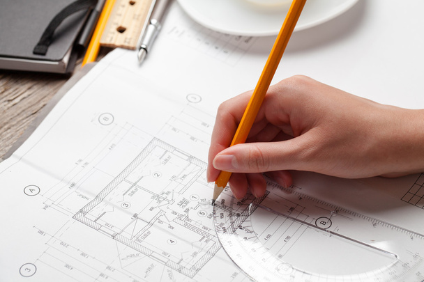 woman holding a pen over a house blueprint - Foto, Imagem