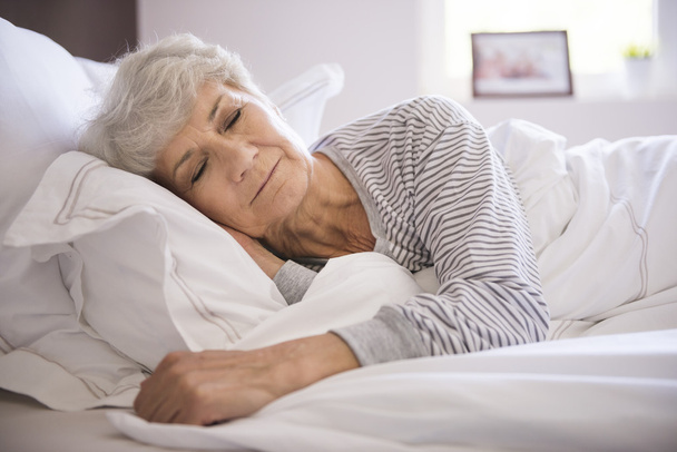 mature woman in bed sleeping - Foto, Imagen