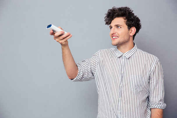 Man holding TV remote  - Photo, Image