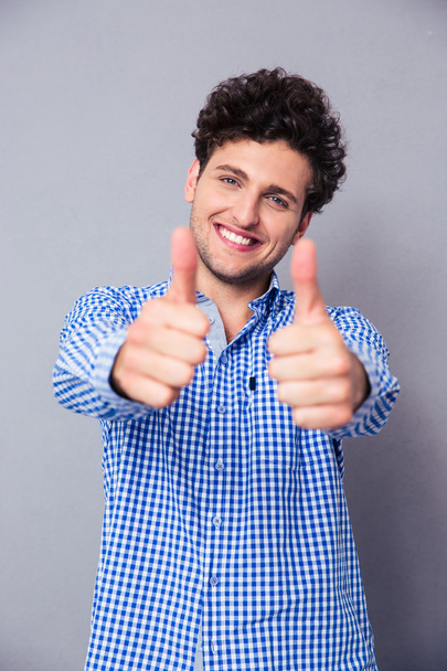 Handsome man showing thumbs up - Photo, image
