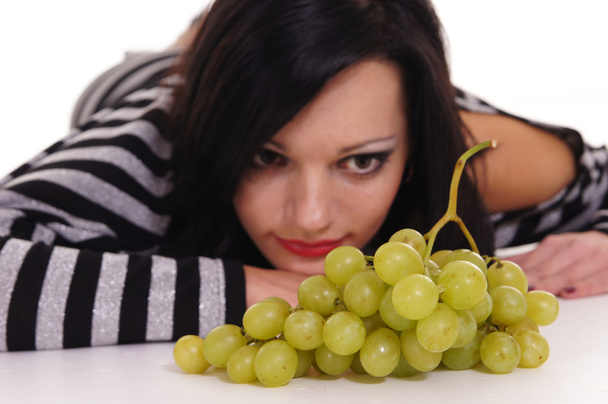 Young woman with grape - 写真・画像