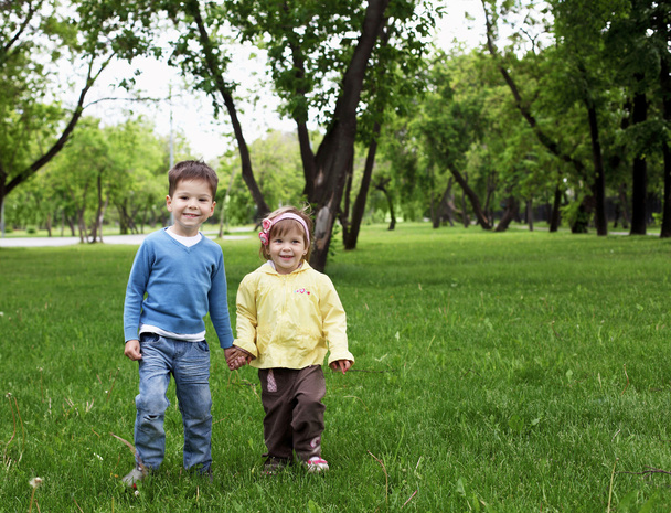Happy sister and brother outdoors - 写真・画像