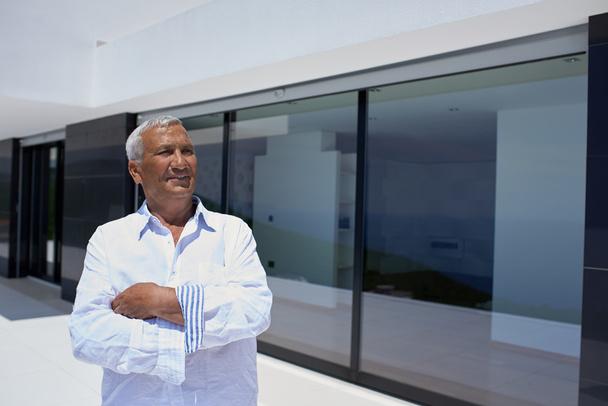 senior man in front of modern home - Фото, изображение