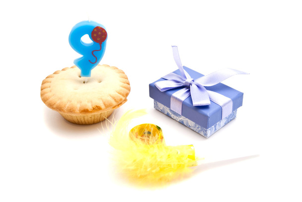 cupcake with nine years birthday candle, gift and whistle - Foto, afbeelding