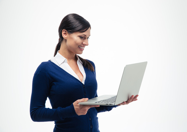 Businesswoman standing and using laptop  - Valokuva, kuva