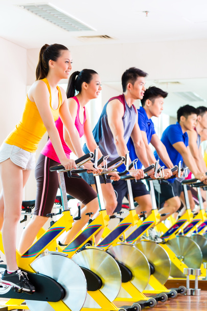 people in spinning bike training at fitness gym - Photo, Image