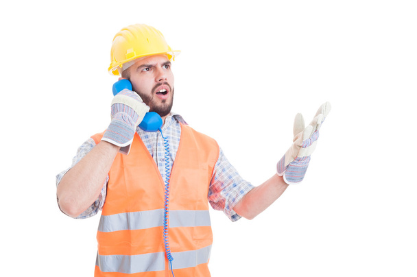 Upset builder arguing on the phone - Фото, зображення
