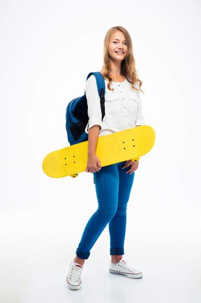 Female student holding skateboard  - Photo, image