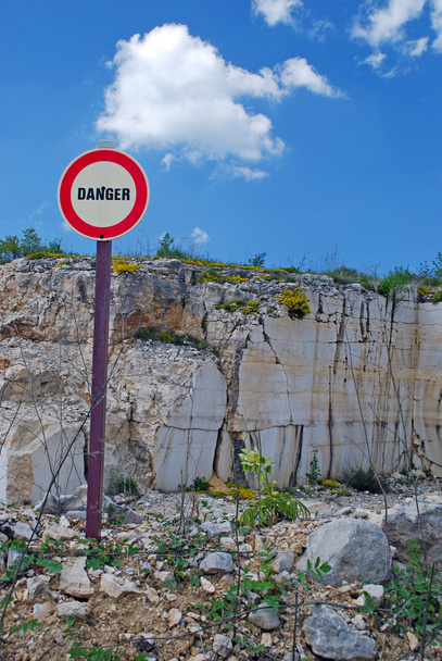 Warning sign in front of geologic formation - Photo, Image